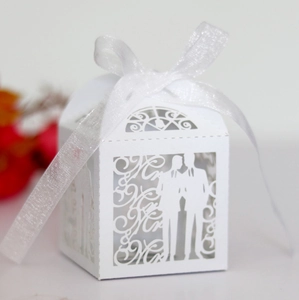 White laser-cut Mr & Mr wedding candy box with elegant ribbon and hollow silhouettes