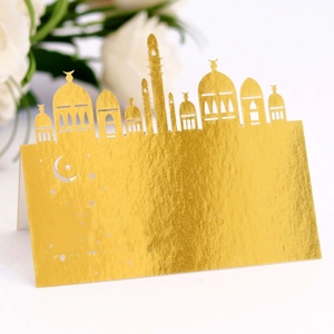 Elegant gold laser cut Eid Mubarak table place card with mosque and crescent moon design