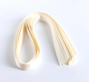 Close-up of premium cream-colored satin ribbons with smooth texture for gift wrapping
