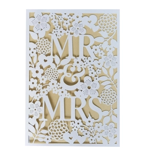 Detailed laser-cut wedding invitation featuring elegant MR & MRS floral hollow design