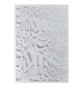 Detailed laser-cut white wedding invitation with elegant Mr & Mrs floral hollow patterns