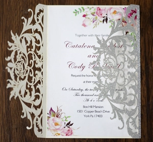Macro detail of laser-cut rose hollow invitation with silver glitter and floral insert