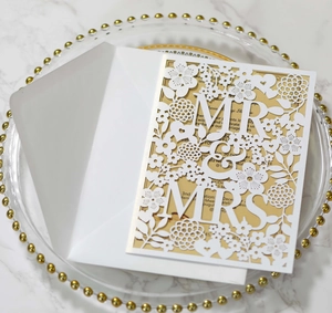 Detail of laser-cut laser-cut Mr & Mrs rose pattern wedding invitations with gold inserts
