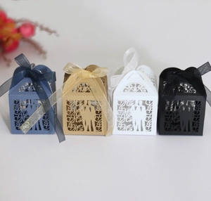 Detail of laser-cut Mr & Mr candy boxes with elegant ribbons in four stylish colors
