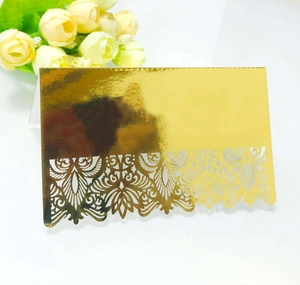 Elegant gold mirror wedding place card with intricate laser cut floral lace patterns