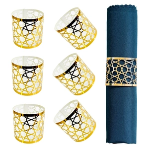 Detailed view of 6 gold geometric napkin rings with star-shaped hollow design for dining