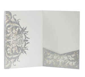 Detail of silver glitter laser cut wedding invitation with intricate rose flower patterns