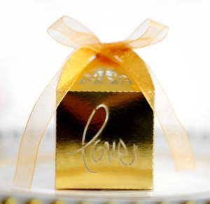 Detailed view of hollow gold gift box with love text and translucent yellow ribbon bow