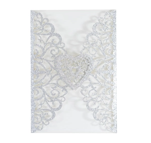 Detail of silver glitter laser-cut floral scroll and heart invitation cover