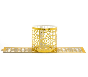 Macro view of gold laser-cut napkin rings with intricate geometric hollow patterns