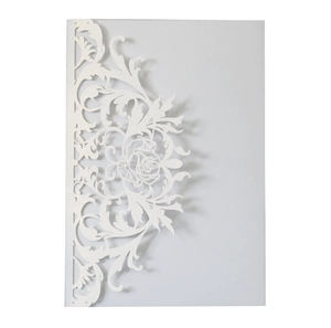 Macro shot of white laser-cut rose pattern on premium pearlescent paper invitation
