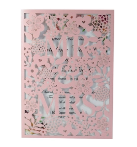 Detail of pink laser cut wedding invitation with hollow floral pattern and MR & MRS text