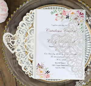 Detailed laser-cut wedding invitation with silver glitter heart and floral inner card
