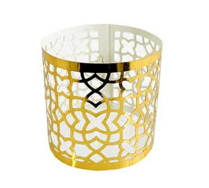 Detail of laser-cut gold reflective napkin ring with elegant Moroccan geometric pattern