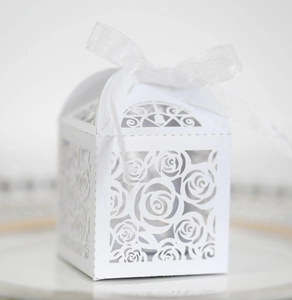 Detail view of laser-cut rose hollow favor box with elegant white ribbon bow