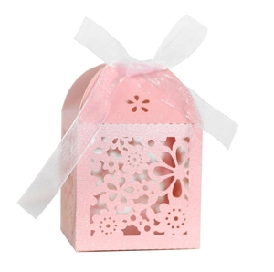 Pink laser-cut wedding favor box with pearl shimmer finish and white ribbon bow