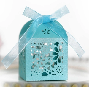 Elegant light blue laser-cut wedding favor box with intricate hollow floral patterns