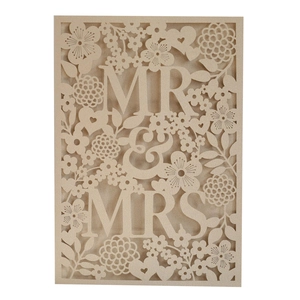 Detail of laser cut wedding invitation card with floral patterns and MR & MRS text