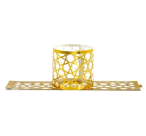 Detail of laser-cut gold star napkin rings with reflective geometric hollow patterns