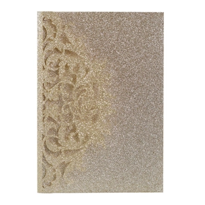 Close-up of laser cut glitter gold floral wedding invitation card with intricate vine detail