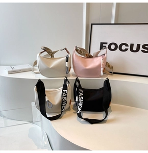Collection of crescent crossbody bags in four colors with stylish patterned straps