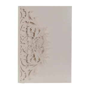Detail view of laser-cut rose patterns on pearlescent paper wedding invitation cover