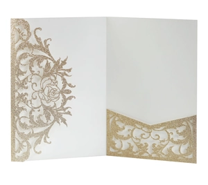 Close-up of laser-cut rose floral patterns on gold glitter wedding invitation card