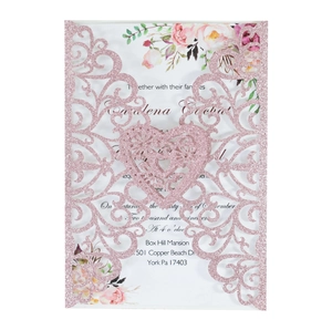 Detail of pink glitter laser-cut wedding invitation with elegant floral inner sheet