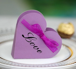 Macro detail of purple heart gift box with pink organza ribbon and Love print on porcelain