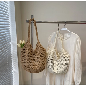Detailed close-up of woven straw tote bags in beige and brown with net-like texture