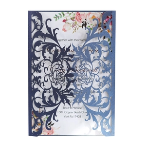 Detail of laser cut navy floral wedding invitation with pink rose inner card