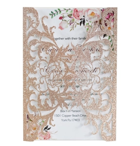 Macro detail of laser-cut rose glitter invitation with elegant floral interior card