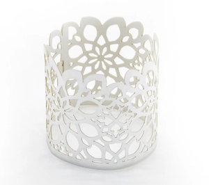 Close-up of elegant white hollowed-out geometric floral napkin ring for wedding decor