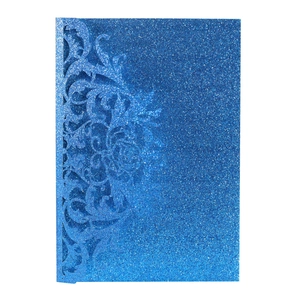Detailed laser-cut blue glitter paper invitation cover with elegant floral patterns
