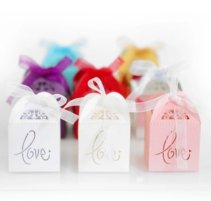 Hollow out LOVE wedding favor boxes with ribbon bows shown in various elegant color options
