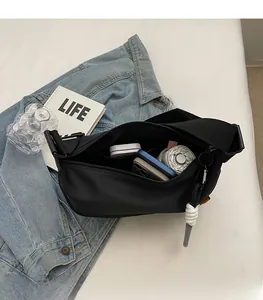 Internal view of black nylon dumpling bag showing large capacity for phone and umbrella