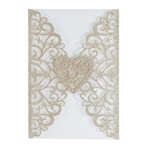Detail of laser-cut heart pattern on gold glitter paper wedding invitation cover
