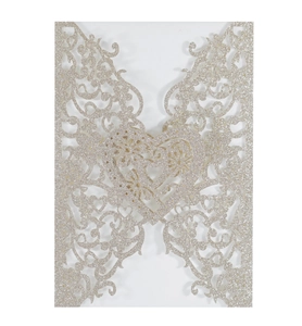 Macro detail of laser-cut butterfly floral invitation with glitter heart pattern