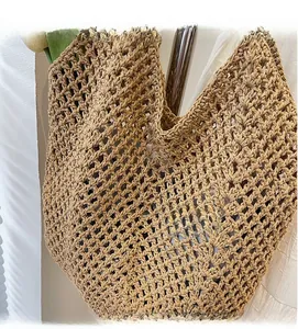 Close-up of woven straw tote bag featuring detailed hollow-out mesh craft for summer use