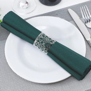Macro shot of silver hollow-out flower napkin ring with intricate geometric laser cutting