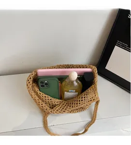 Spacious interior of a khaki crochet tote bag holding a tablet and phone