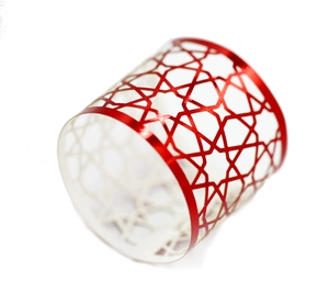Close-up of red hollowed-out star pattern metal napkin ring with shiny coating