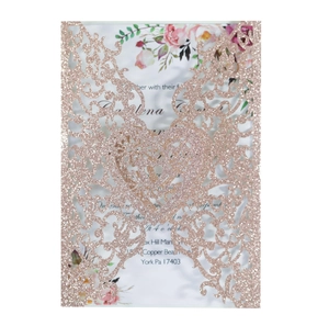 Macro detail of rose gold laser-cut floral invitation cover with heart-shaped center
