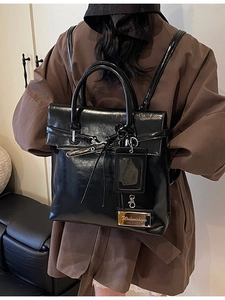 Fashionable black glossy leather backpack for women with adjustable straps and hanging ID tag