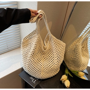 Detail of hollow mesh woven pattern on cream large capacity shoulder tote bag