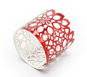 Detailed laser-cut floral pattern on a bright red festive napkin ring holder