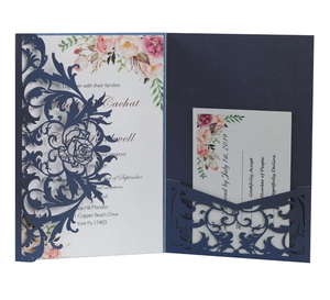 Detail of laser-cut navy blue wedding invitation with watercolor floral inner cards
