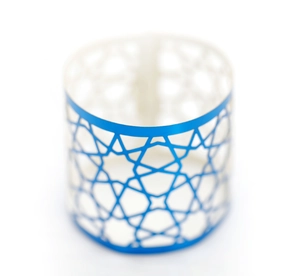 Detail view of a blue geometric star hollow-out metal napkin ring for hotel table decor