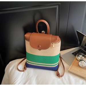 Detail of multi-colored woven texture and brown leather strap on a stylish backpack