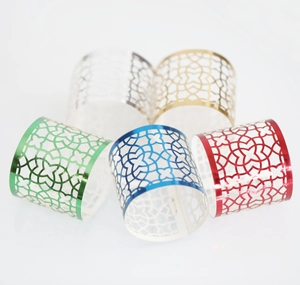 Detail of hollow geometric metal napkin rings in five vibrant metallic finishes